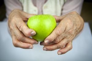 Lady holding a green apple